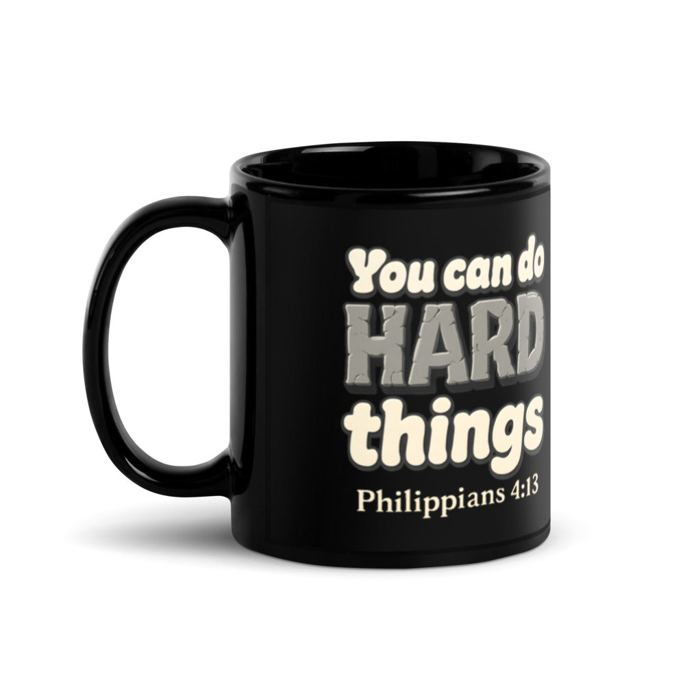 11 oz black glossy mug printed with “You can do HARD things” in cracked stone letters and Philippians 4:13