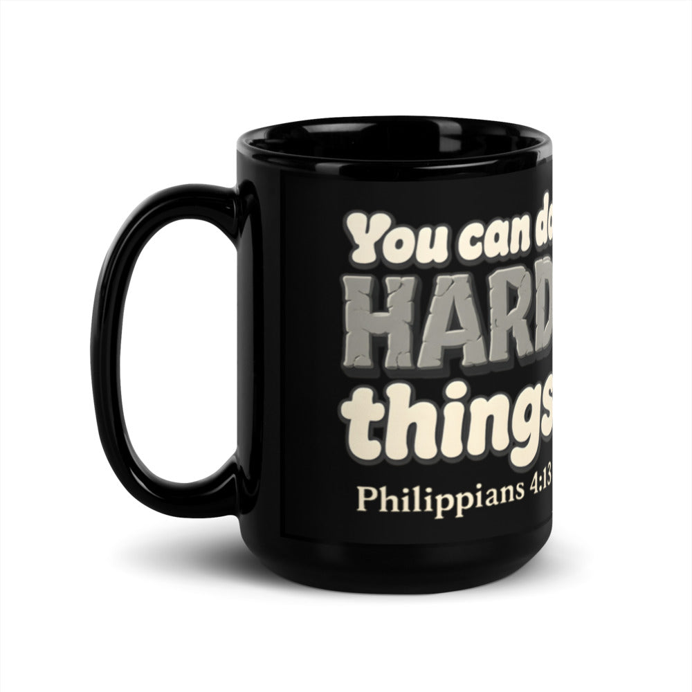 15 oz black glossy mug printed with “You can do HARD things” in cracked stone letters and Philippians 4:13