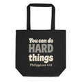 Black tote bag printed with “You can do HARD things” in cracked stone letters and Philippians 4:13