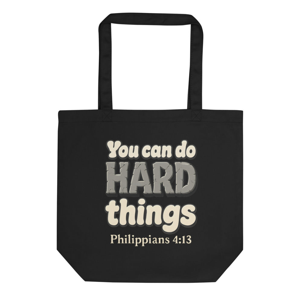 Black tote bag printed with “You can do HARD things” in cracked stone letters and Philippians 4:13