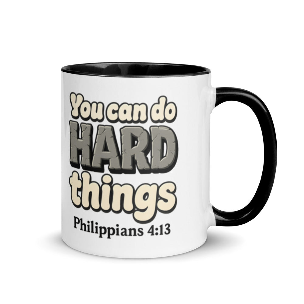 White mug with a black inside and handle printed with “You can do HARD things” in cracked stone letters and Philippians 4:13