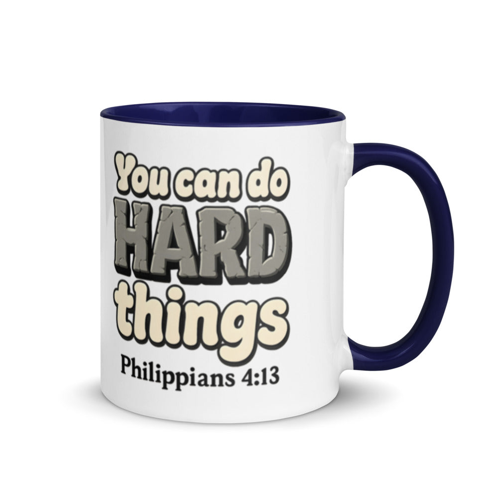 White mug with a dark blue inside and handle printed with “You can do HARD things” in cracked stone letters and Philippians 4:13