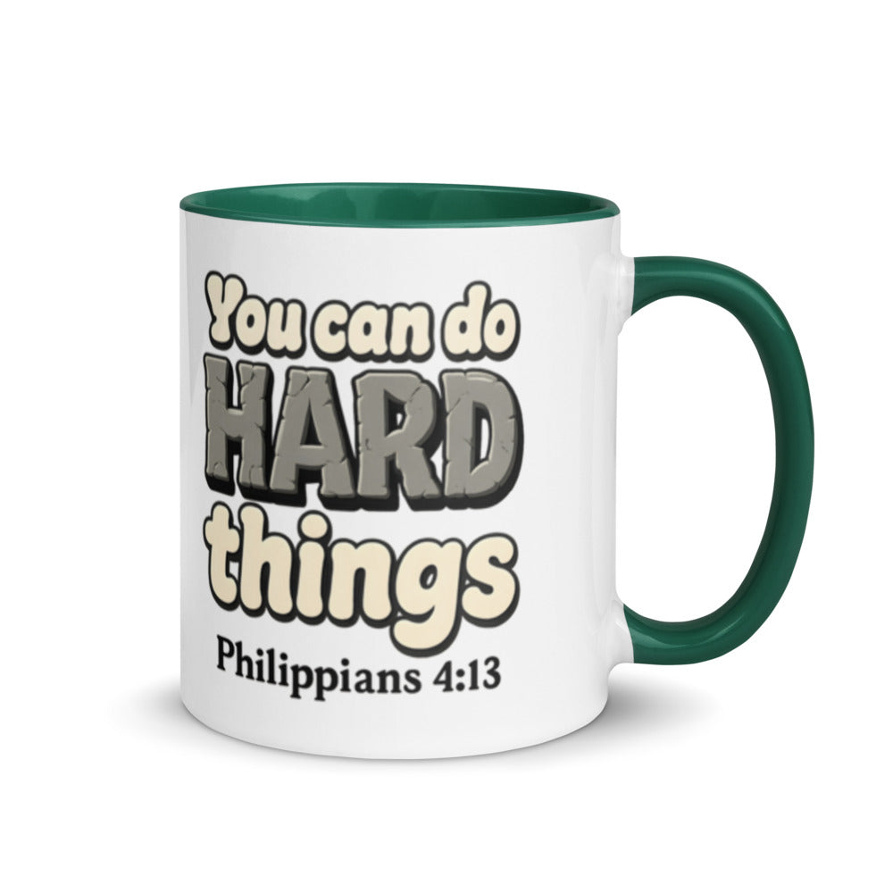 White mug with a dark green inside and handle printed with “You can do HARD things” in cracked stone letters and Philippians 4:13
