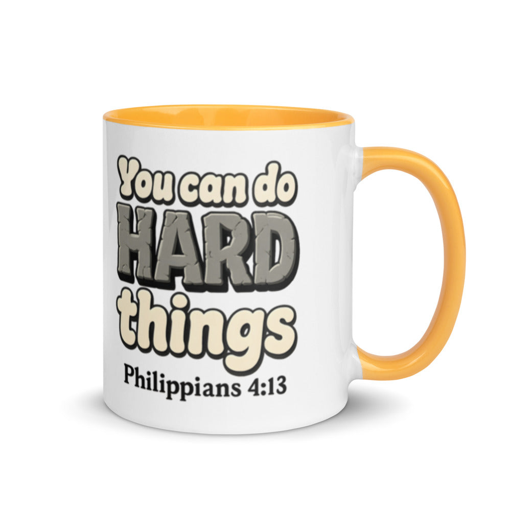 White mug with a golden yellow inside and handle printed with “You can do HARD things” in cracked stone letters and Philippians 4:13