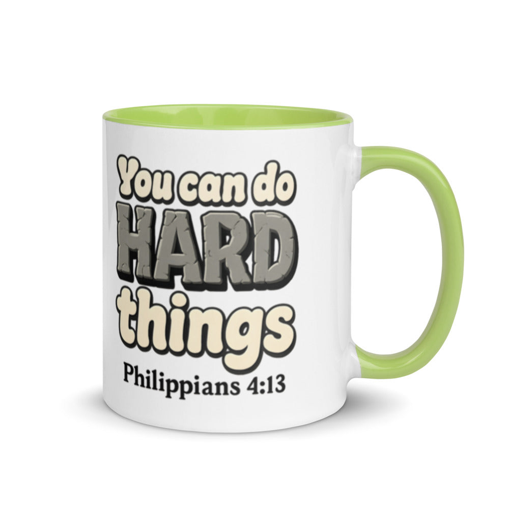 White mug with a green inside and handle printed with “You can do HARD things” in cracked stone letters and Philippians 4:13
