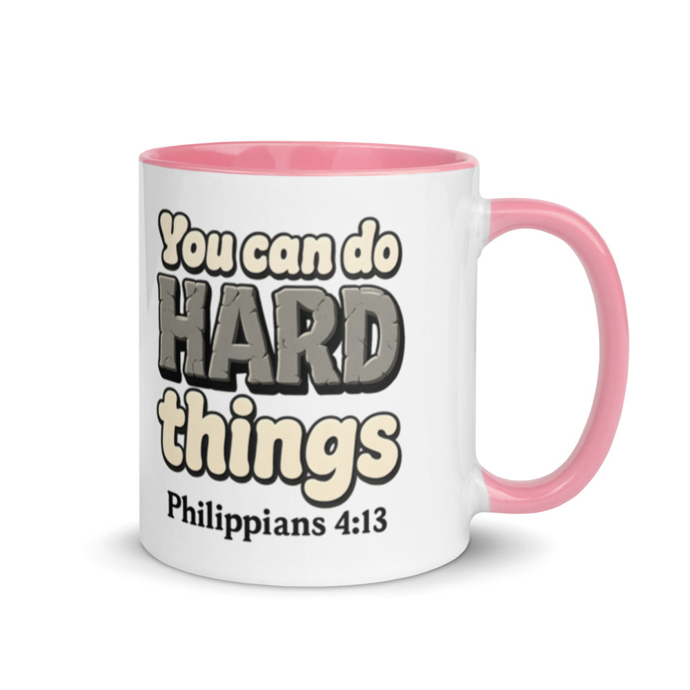 White mug with a pink inside and handle printed with “You can do HARD things” in cracked stone letters and Philippians 4:13