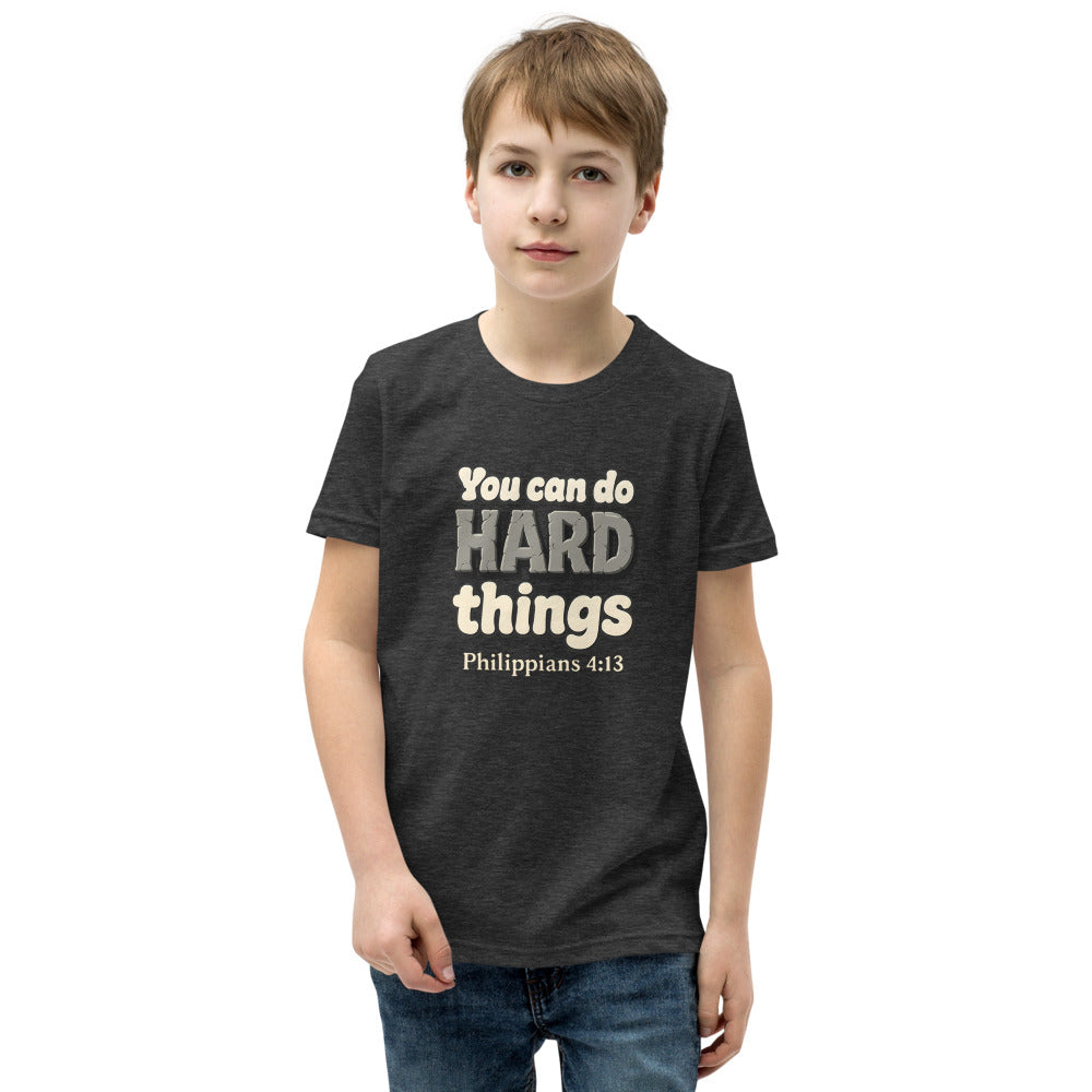 Dark Grey Heather youth t-shirt printed with “You can do HARD things” in cracked stone letters and Philippians 4:13