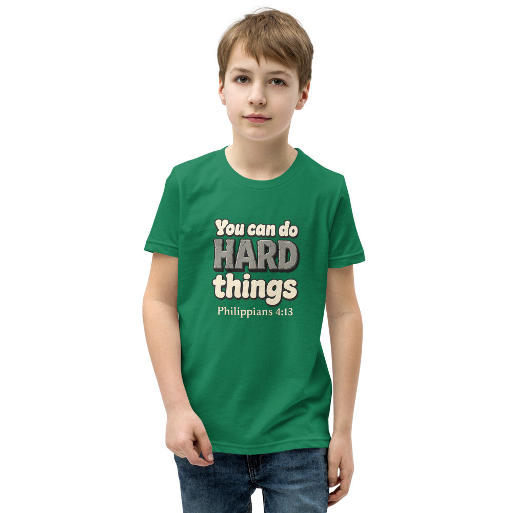 Kelly youth t-shirt printed with “You can do HARD things” in cracked stone letters and Philippians 4:13